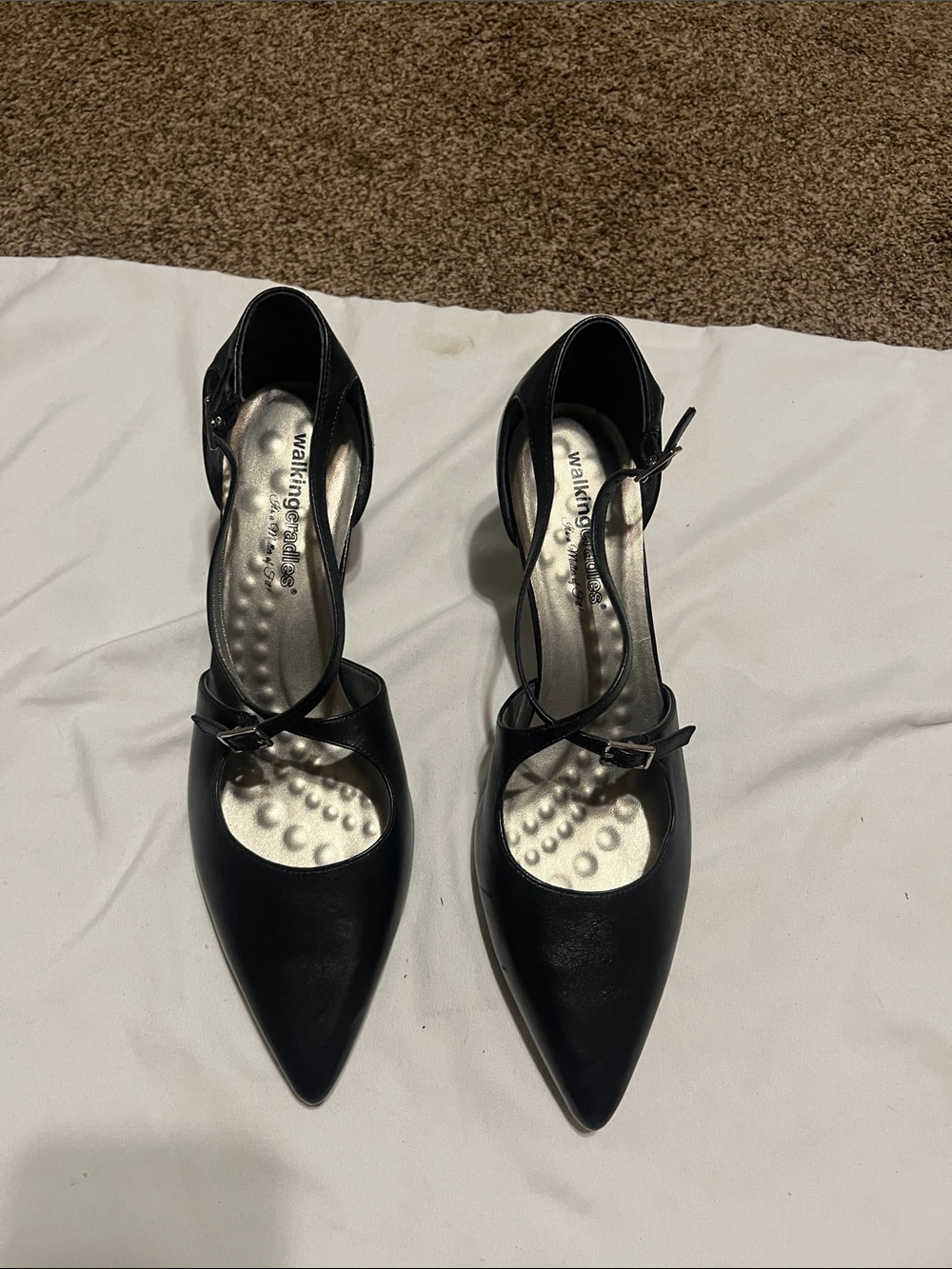 Walking cradles black leather heels.